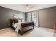Bedroom with gray walls, a ceiling fan, a dark wood sleigh bed, and bright windows with sheer curtains at 10330 Lions Path, Lone Tree, CO 80124