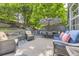 Charming outdoor deck featuring comfortable wicker seating, a dining area, and lush green surroundings at 10330 Lions Path, Lone Tree, CO 80124