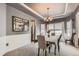 Dining area featuring gray walls, a decorative mirror, and a view into the kitchen at 10330 Lions Path, Lone Tree, CO 80124