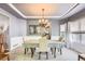 Elegant dining room featuring stylish lighting, neutral tones, and modern accents at 10330 Lions Path, Lone Tree, CO 80124