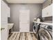 Well-equipped laundry room featuring a modern washer and dryer, storage cabinets, and a utility sink at 10330 Lions Path, Lone Tree, CO 80124