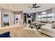 Inviting living room with a ceiling fan, fireplace, built-in shelves, and a large sectional sofa at 10330 Lions Path, Lone Tree, CO 80124
