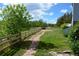 A backyard featuring a grass lawn, stone walkway, and a wooden fence at 7665 E Eastman Ave # 111A, Denver, CO 80231