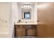 Bathroom vanity with wooden cabinets and drawers beneath a white sink basin at 7665 E Eastman Ave # 111A, Denver, CO 80231