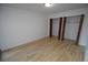 Bedroom space with wood-look floors and a spacious closet area at 7665 E Eastman Ave # 111A, Denver, CO 80231