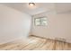 Cozy bedroom with laminate flooring, a window, and neutral colored walls at 7665 E Eastman Ave # 111A, Denver, CO 80231