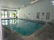 Indoor pool area with natural lighting, surrounding tile, and clear blue water at 7665 E Eastman Ave # 111A, Denver, CO 80231