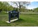 Hutchinson Park sign, with green grass, trees and walking area in the background at 7665 E Eastman Ave # 111A, Denver, CO 80231