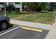 Parking lot, with yellow parking blocks and sidewalk access to building at 7665 E Eastman Ave # 111A, Denver, CO 80231