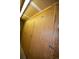 Hallway with wooden storage units featuring locks and number plates on the doors at 7665 E Eastman Ave # 111A, Denver, CO 80231