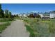 Gravel walking path near apartments surrounded by foliage, with bridge and fence at 7665 E Eastman Ave # 111A, Denver, CO 80231