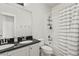 Bathroom with double sink vanity, granite counters, and shower-tub combo at 3529 Xanthia Ct, Denver, CO 80238