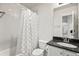 Clean bathroom with tiled shower, granite countertop, and a view into the main living space at 3529 Xanthia Ct, Denver, CO 80238