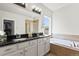Bright bathroom featuring double sinks, a bathtub, and a separate shower at 3529 Xanthia Ct, Denver, CO 80238