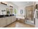 Elegant bathroom featuring a double vanity, soaking tub, a glass shower, and tiled flooring for a spa-like experience at 3529 Xanthia Ct, Denver, CO 80238