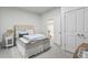 Bright bedroom with neutral carpet, a comfortable mattress, and access to an adjoining room at 3529 Xanthia Ct, Denver, CO 80238