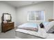 Cozy bedroom with a large window, classic dresser, and comfortable mattress at 3529 Xanthia Ct, Denver, CO 80238