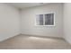 This cozy bedroom offers soft carpeting, a bright window, and neutral walls at 3529 Xanthia Ct, Denver, CO 80238