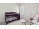 Cozy Bedroom with dark wood crib, shuttered window, and comfortable seating at 3529 Xanthia Ct, Denver, CO 80238