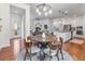 Bright dining room open to the kitchen and living area with modern chandelier at 3529 Xanthia Ct, Denver, CO 80238