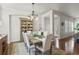 Charming dining room with a rustic table, upholstered chairs, and a stylish chandelier at 3529 Xanthia Ct, Denver, CO 80238