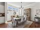 Elegant dining room with natural light, a decorative hutch, and a rustic wood table at 3529 Xanthia Ct, Denver, CO 80238