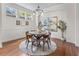 Elegant dining room with modern lighting fixture and ample natural light at 3529 Xanthia Ct, Denver, CO 80238