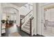 Bright entryway featuring a staircase and open access to the living area with hardwood floors at 3529 Xanthia Ct, Denver, CO 80238