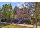Charming brick two-story home with a well-manicured lawn and mature trees in a residential neighborhood at 3529 Xanthia Ct, Denver, CO 80238