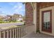 Inviting front porch view with brick accents and a glimpse of the peaceful neighborhood at 3529 Xanthia Ct, Denver, CO 80238