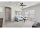 Bright living room featuring modern decor, a ceiling fan, and ample natural light at 3529 Xanthia Ct, Denver, CO 80238