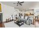 Open concept living room with hardwood floors, comfortable seating, and views of the kitchen at 3529 Xanthia Ct, Denver, CO 80238