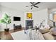Bright living room with hardwood floors, a fireplace, and a ceiling fan at 3529 Xanthia Ct, Denver, CO 80238