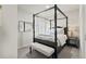 Well-lit main bedroom with canopy bed, bench, and stylish decor at 3529 Xanthia Ct, Denver, CO 80238