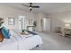 Bright main bedroom offering a king bed, soft carpet, and neutral decor, creating an inviting retreat at 3529 Xanthia Ct, Denver, CO 80238