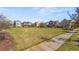 Picturesque neighborhood view showcasing a large communal green space surrounded by colorful homes at 3529 Xanthia Ct, Denver, CO 80238