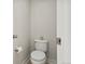 Compact powder room with a toilet, white walls, and modern fixtures at 3529 Xanthia Ct, Denver, CO 80238