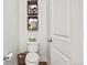 Small powder room features a classic toilet and decorative wall shelves at 3529 Xanthia Ct, Denver, CO 80238