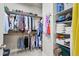 Organized walk-in closet features ample storage, with shelves and hanging space for clothing and accessories at 3529 Xanthia Ct, Denver, CO 80238