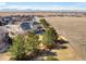 Aerial view of a home with lush trees and a wooden fence at 4939 Silver Feather Cir, Broomfield, CO 80023