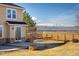 A house with stone accents and a wooden fence with mountain views at 4939 Silver Feather Cir, Broomfield, CO 80023