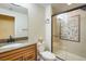 This bathroom features granite countertops, a sink, a toilet, and glass door shower at 4939 Silver Feather Cir, Broomfield, CO 80023