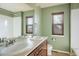 Well-lit bathroom with double sinks, a large mirror, and a shower/tub combination at 4939 Silver Feather Cir, Broomfield, CO 80023