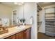 Well-lit bathroom featuring granite countertops, vanity, and a walk-in closet at 4939 Silver Feather Cir, Broomfield, CO 80023