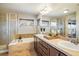 Bright bathroom with double sinks, large mirror, tub, and a glass enclosed shower at 4939 Silver Feather Cir, Broomfield, CO 80023