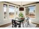 Bright dining room with large windows offering scenic views and a stylish chandelier at 4939 Silver Feather Cir, Broomfield, CO 80023