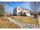 Inviting two-story home with a lush front yard, rock garden, and an attached two-car garage at 4939 Silver Feather Cir, Broomfield, CO 80023