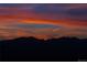 Colorful sunset sky over the dark outline of distant mountain ridges at 4939 Silver Feather Cir, Broomfield, CO 80023