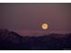 Full moon over silhouetted mountains, creating a serene and picturesque landscape at 4939 Silver Feather Cir, Broomfield, CO 80023