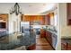 Updated kitchen with stone counters, stainless appliances, and wood cabinets at 4939 Silver Feather Cir, Broomfield, CO 80023